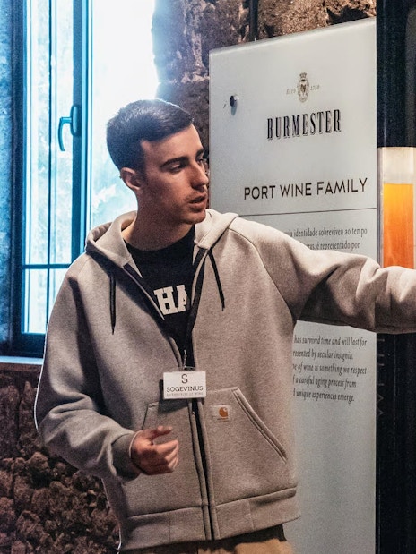 Tour guide explaining port wine history at Burmester winery in Porto.