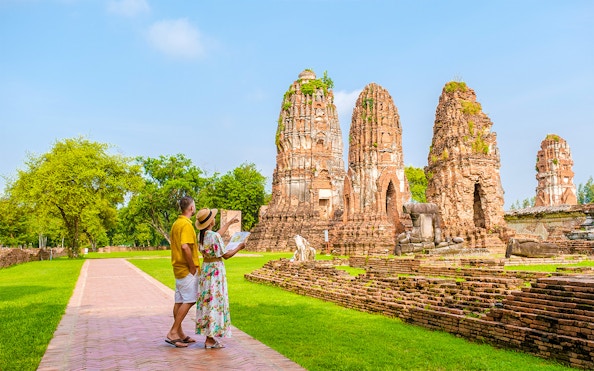 Tourists exploring ancient ruins in Ayutthaya, Thailand, during the Grand Pearl River Cruise.