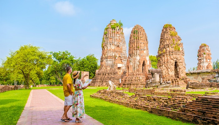 Tourists exploring ancient ruins in Ayutthaya, Thailand, during the Grand Pearl River Cruise.