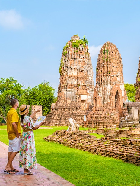 Tourists exploring ancient ruins in Ayutthaya, Thailand, during the Grand Pearl River Cruise.