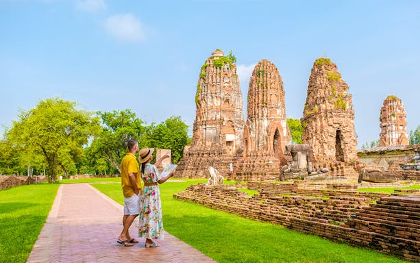 Tourists exploring ancient ruins in Ayutthaya, Thailand, during the Grand Pearl River Cruise.