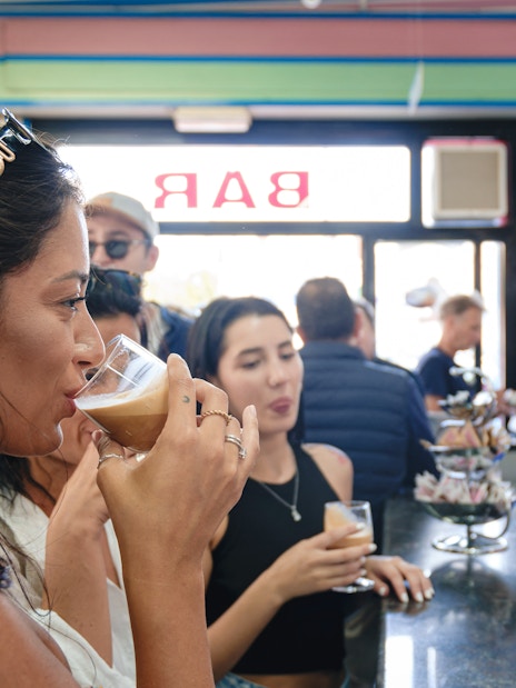 Tourists enjoying coffee tasting at a bar in Polignano a Mare.