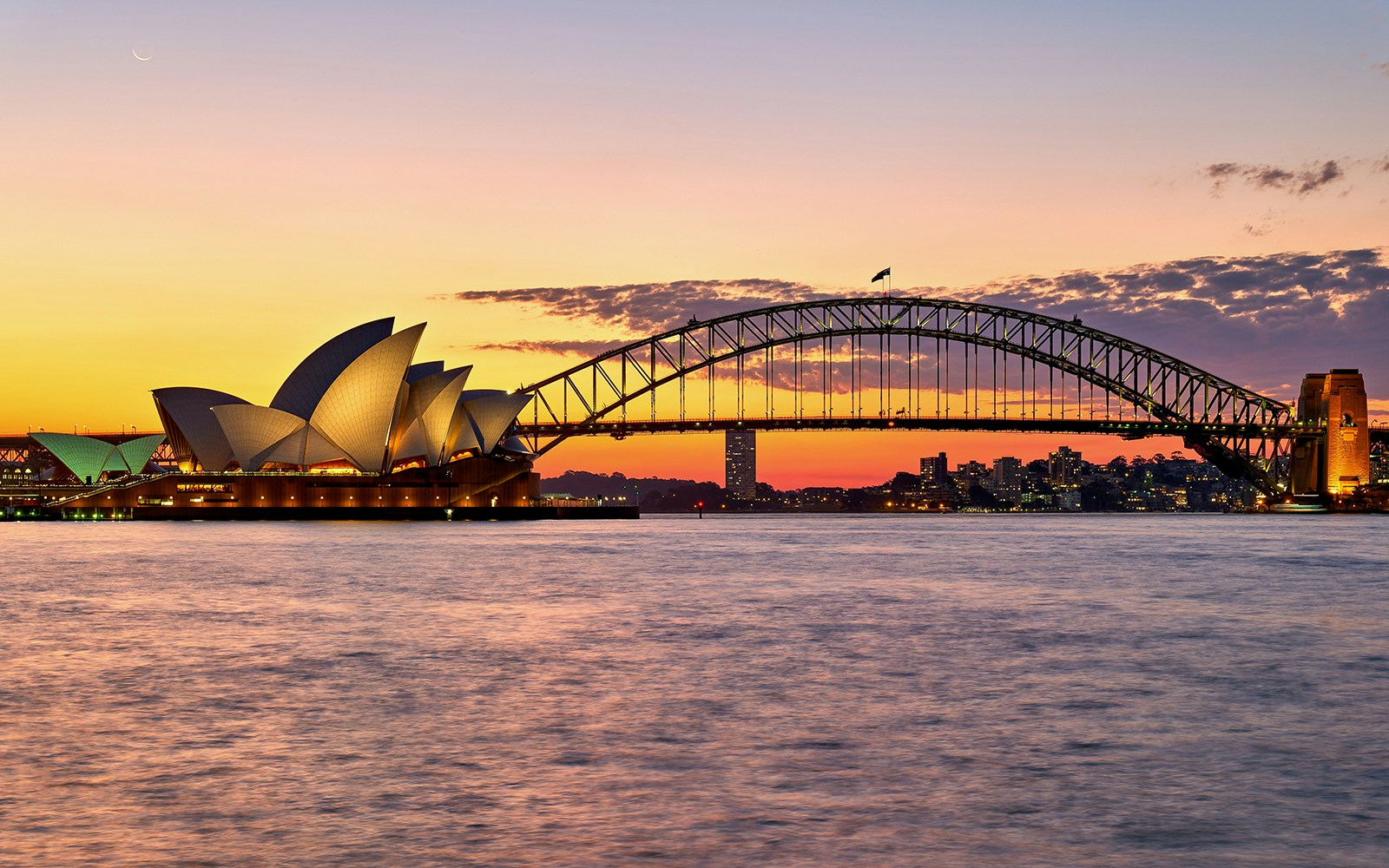 Sydney Opera House and Harbour Bridge at sunset during a harbour cruise.