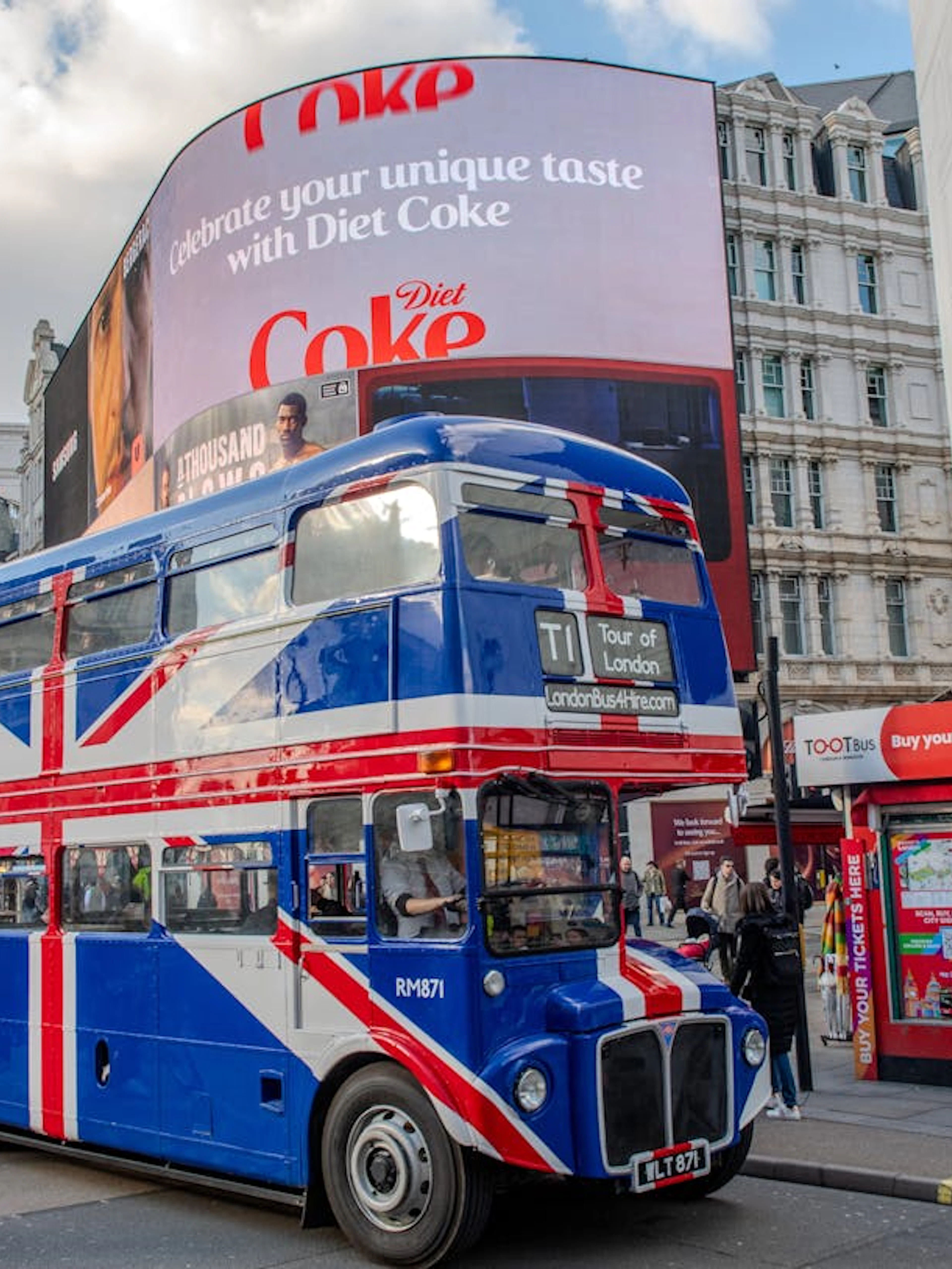 Union Jack double-decker bus at Piccadilly Circus, Central London, for afternoon tea tour.