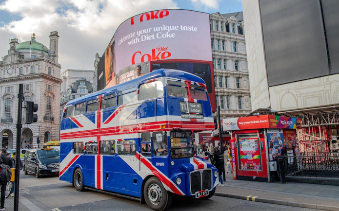 Union Jack double-decker bus at Piccadilly Circus, Central London, for afternoon tea tour.