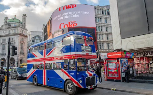 Union Jack double-decker bus at Piccadilly Circus, Central London, for afternoon tea tour.