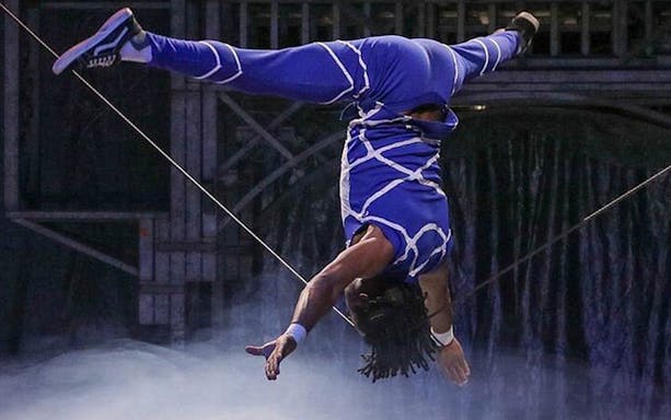 Performer in blue costume doing aerial acrobatics at Big Apple Circus Holiday Show.