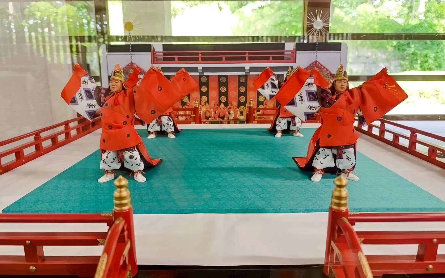 Traditional Japanese dancers in red costumes perform at Tokyo's Imperial Palace.