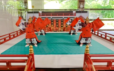 Traditional Japanese dancers in red costumes perform at Tokyo's Imperial Palace.