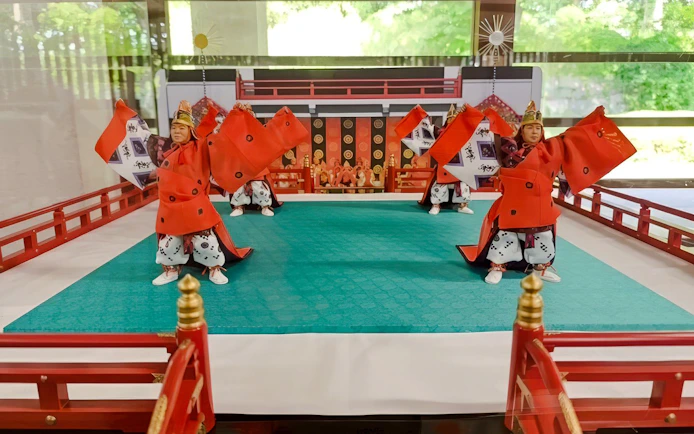 Traditional Japanese dancers in red costumes perform at Tokyo's Imperial Palace.