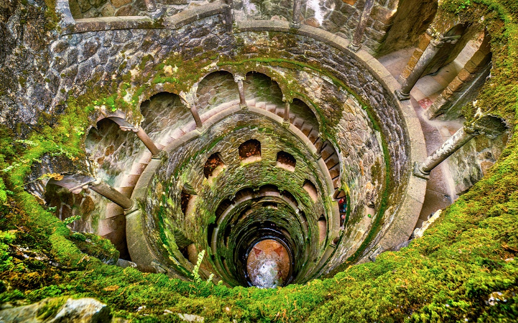 Quinta da Regaleira's Initiation Well with spiral staircase in Sintra, Portugal.