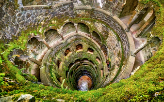 Quinta da Regaleira's Initiation Well with spiral staircase in Sintra, Portugal.