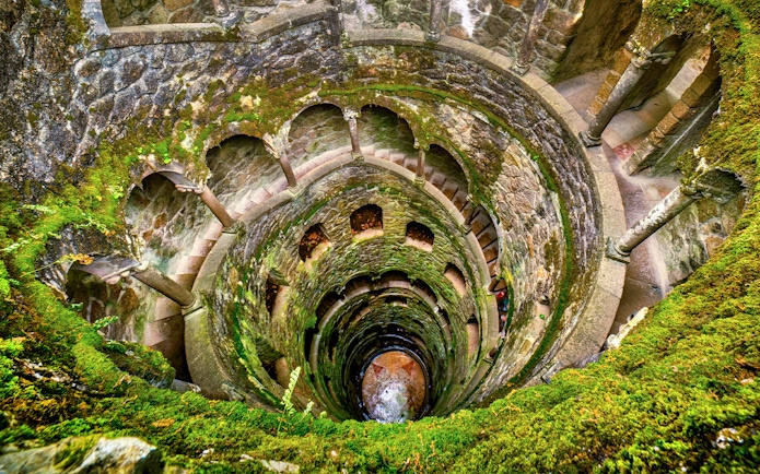 Quinta da Regaleira's Initiation Well with spiral staircase in Sintra, Portugal.