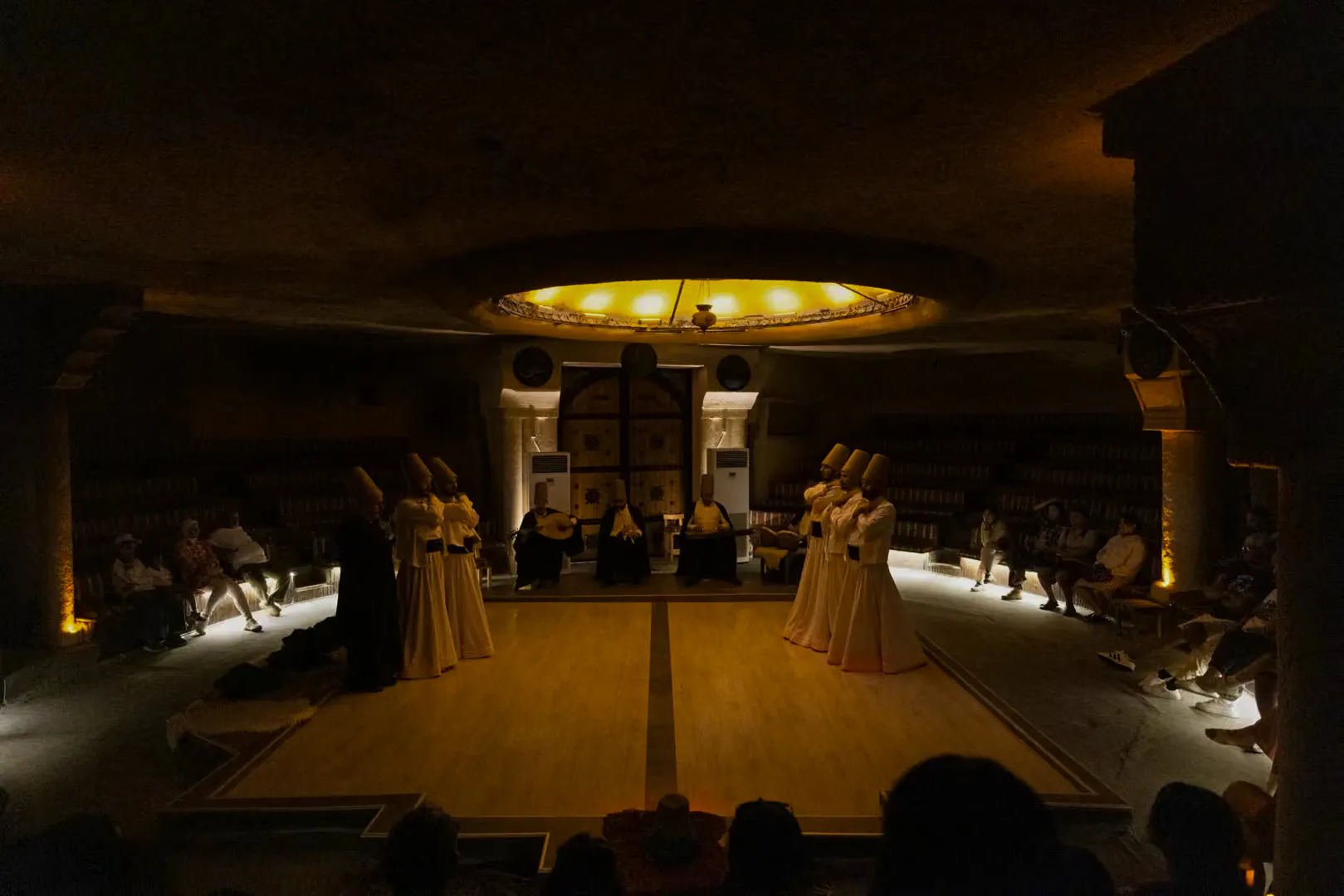 Whirling Dervishes performing Sema ceremony in a cave setting, Cappadocia.