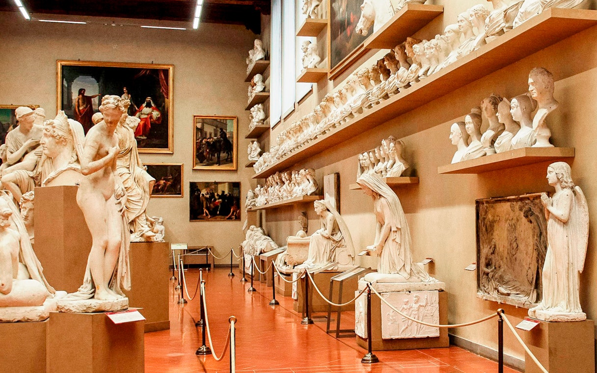 Accademia Gallery interior with classical statues and busts on display.