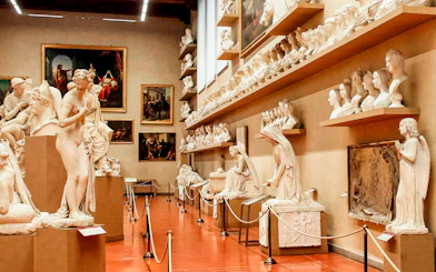 Accademia Gallery interior with classical statues and busts on display.