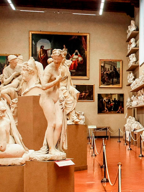 Accademia Gallery interior with classical statues and busts on display.
