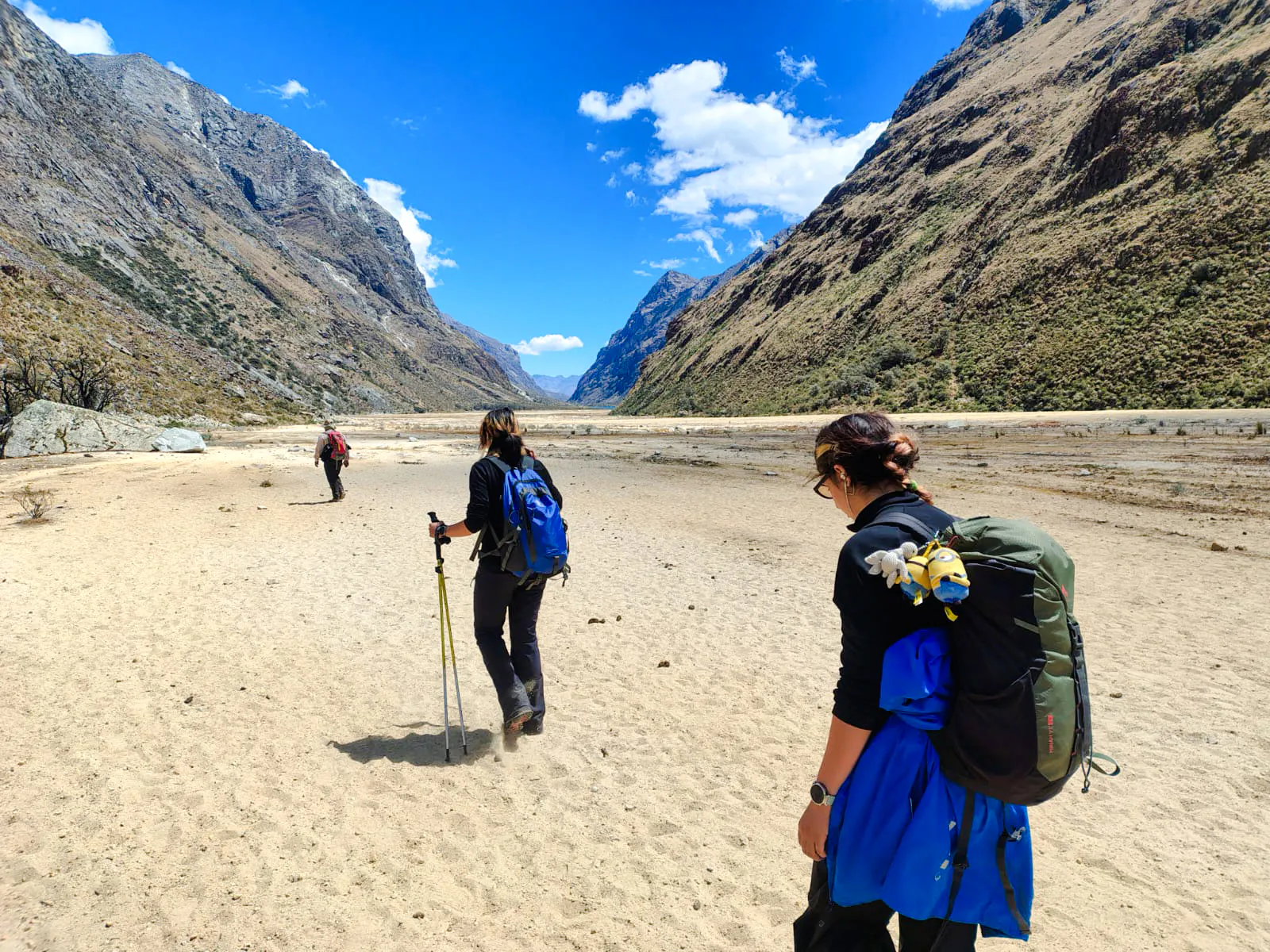 Hikers on Santa Cruz Trek, surrounded by Andean mountains, Vaqueria to Cashapampa, Peru.