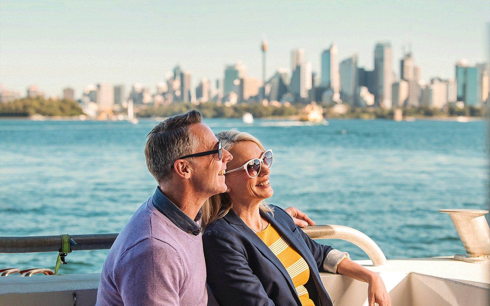 Couple enjoying Sydney Harbour views on Captain Cook Hop-On-Hop-Off Cruise.