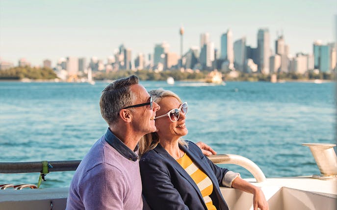Couple enjoying Sydney Harbour views on Captain Cook Hop-On-Hop-Off Cruise.