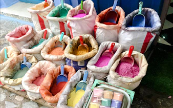 Colorful spice bags at a market in Amman, part of the Amman City Sightseeing Tour.