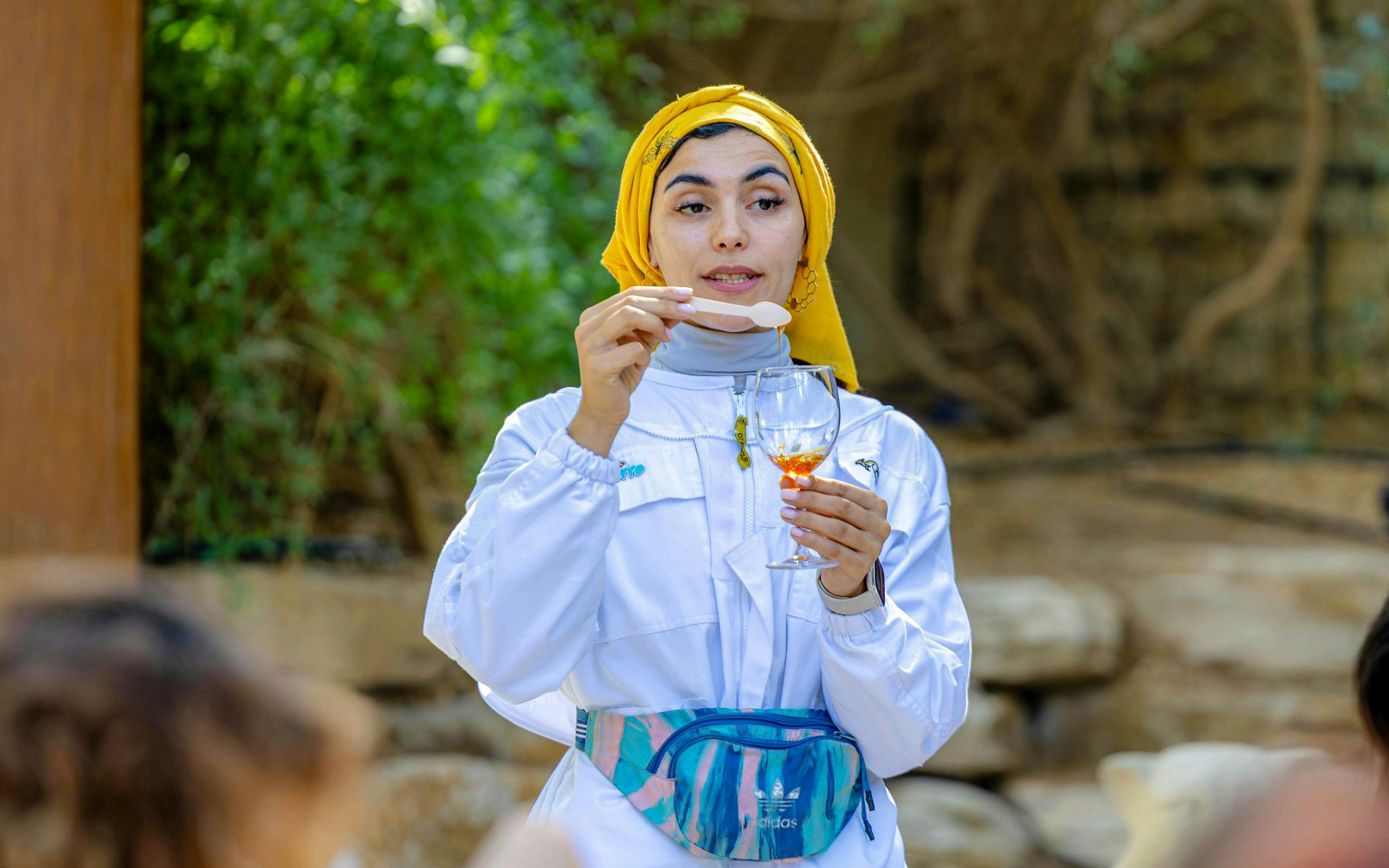 Guide demonstrating honey tasting at A Taste of the Hive, Expo City Dubai.