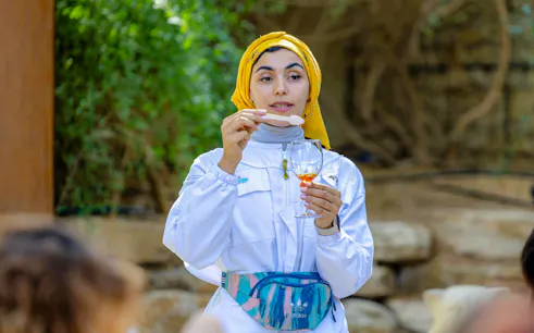 Guide demonstrating honey tasting at A Taste of the Hive, Expo City Dubai.
