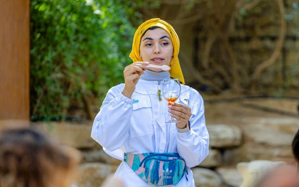 Guide demonstrating honey tasting at A Taste of the Hive, Expo City Dubai.