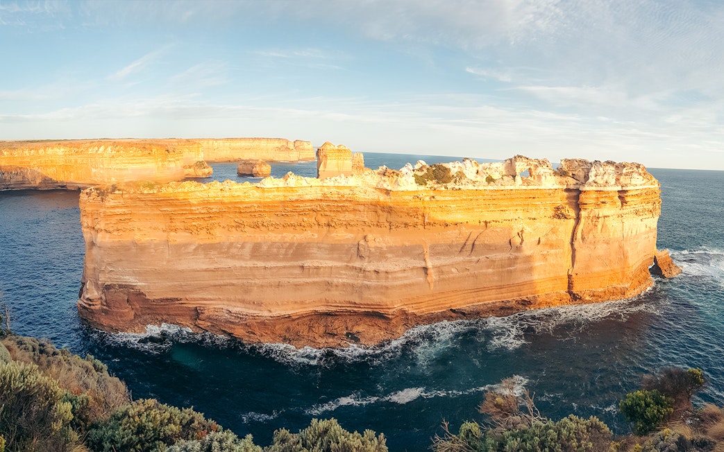 Great Ocean Road coastal rock formations at sunset, Australia.