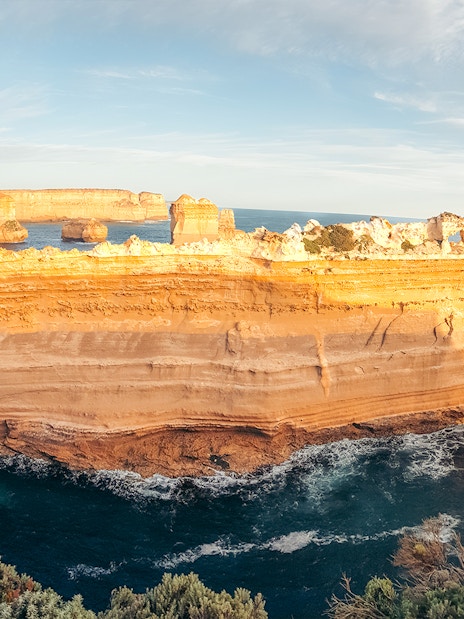 Great Ocean Road coastal rock formations at sunset, Australia.