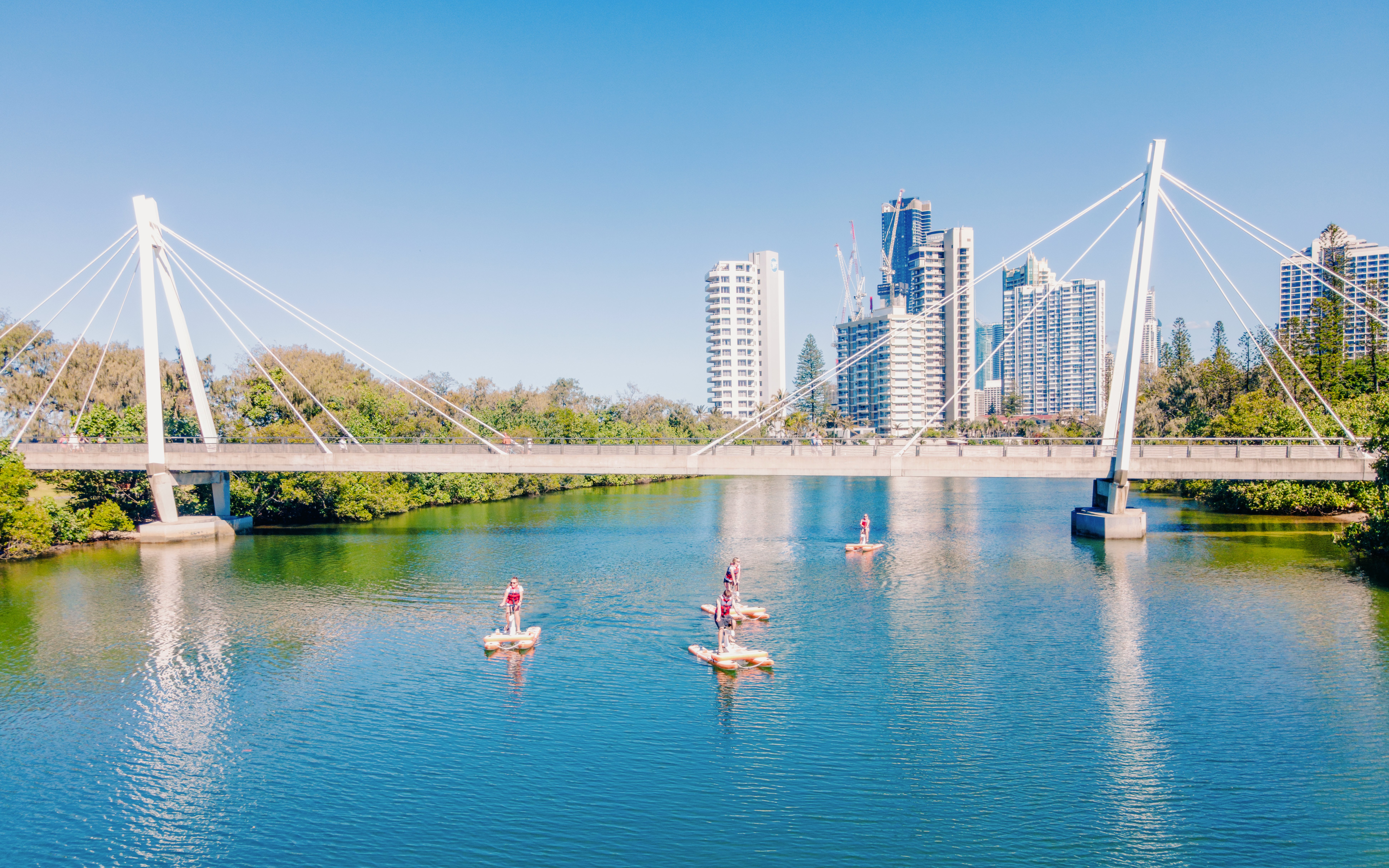 Tourists riding waterbikes near Kangaroo Point Bridge, Gold Coast.