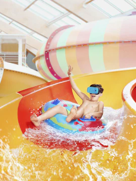 Child enjoying water slide at Aquapalace Prague.