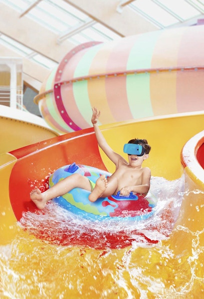 Child enjoying water slide at Aquapalace Prague.