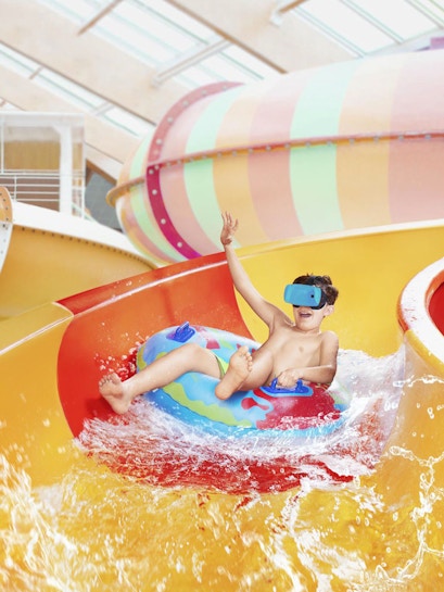 Child enjoying water slide at Aquapalace Prague.