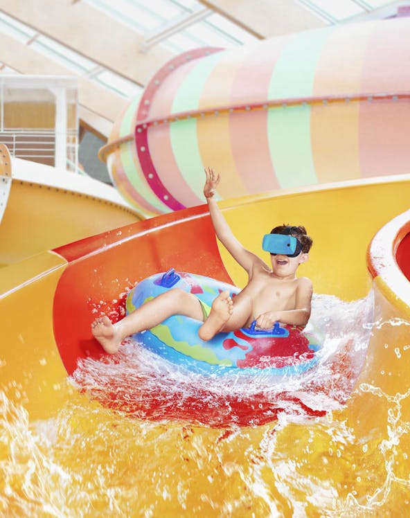Child enjoying water slide at Aquapalace Prague.