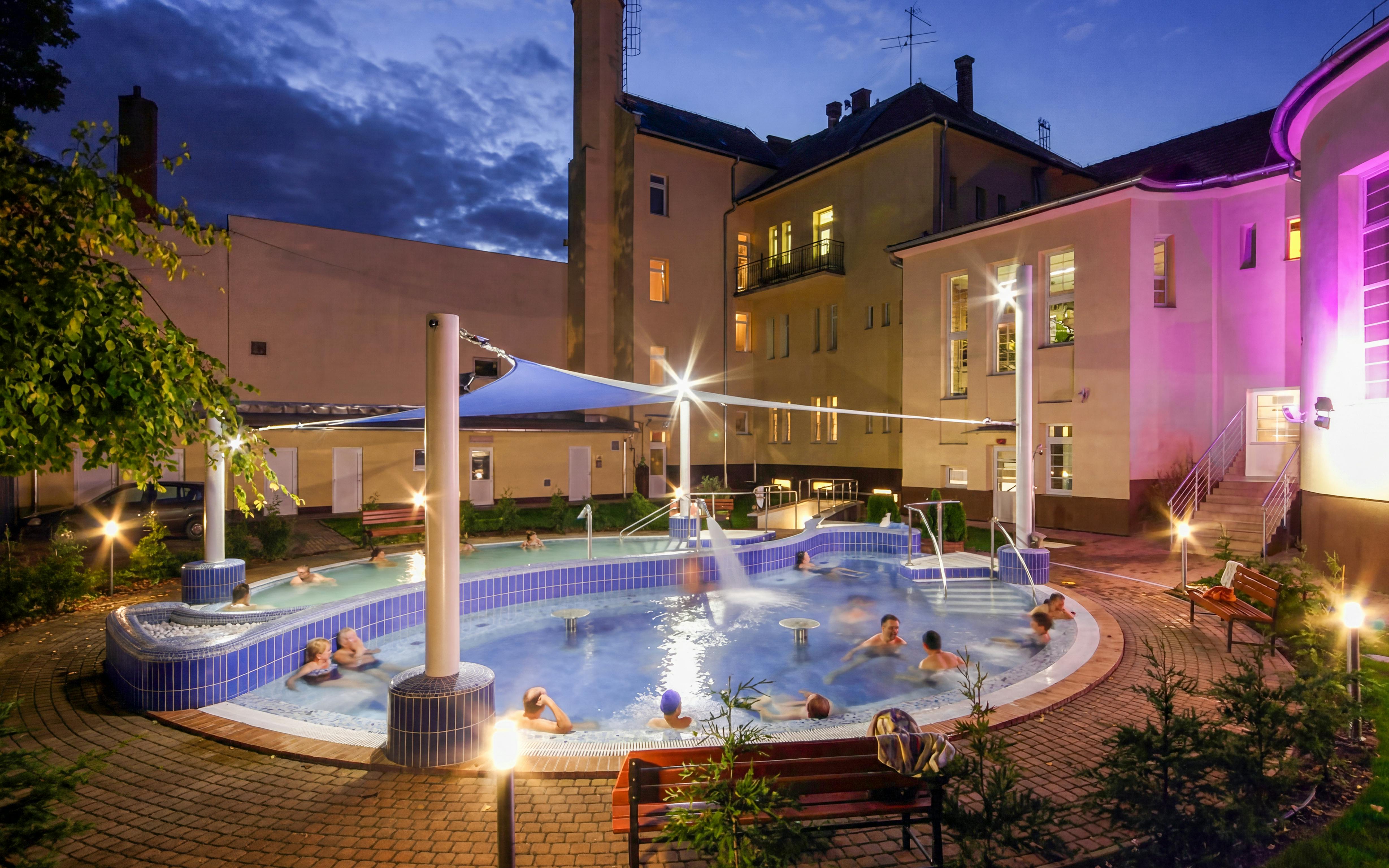 Outdoor thermal pool at Dandar Spa during evening, Budapest.