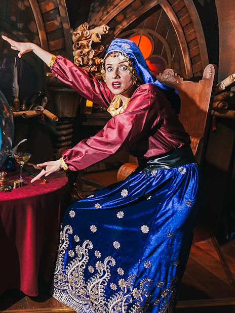 Fortune teller with Shrek's face in a crystal ball at Shrek’s Adventure! London.