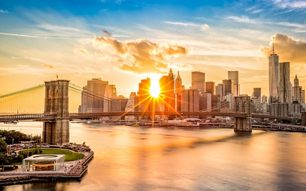 Brooklyn Bridge and Manhattan skyline at sunset, New York City.