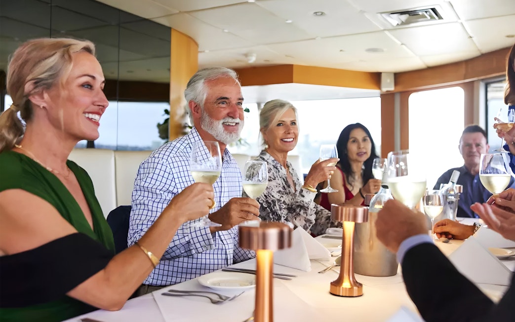 Group enjoying a three-course dining cruise with wine.