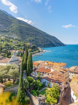 Aerial view of Lake Garda with hillside village and waterfront.