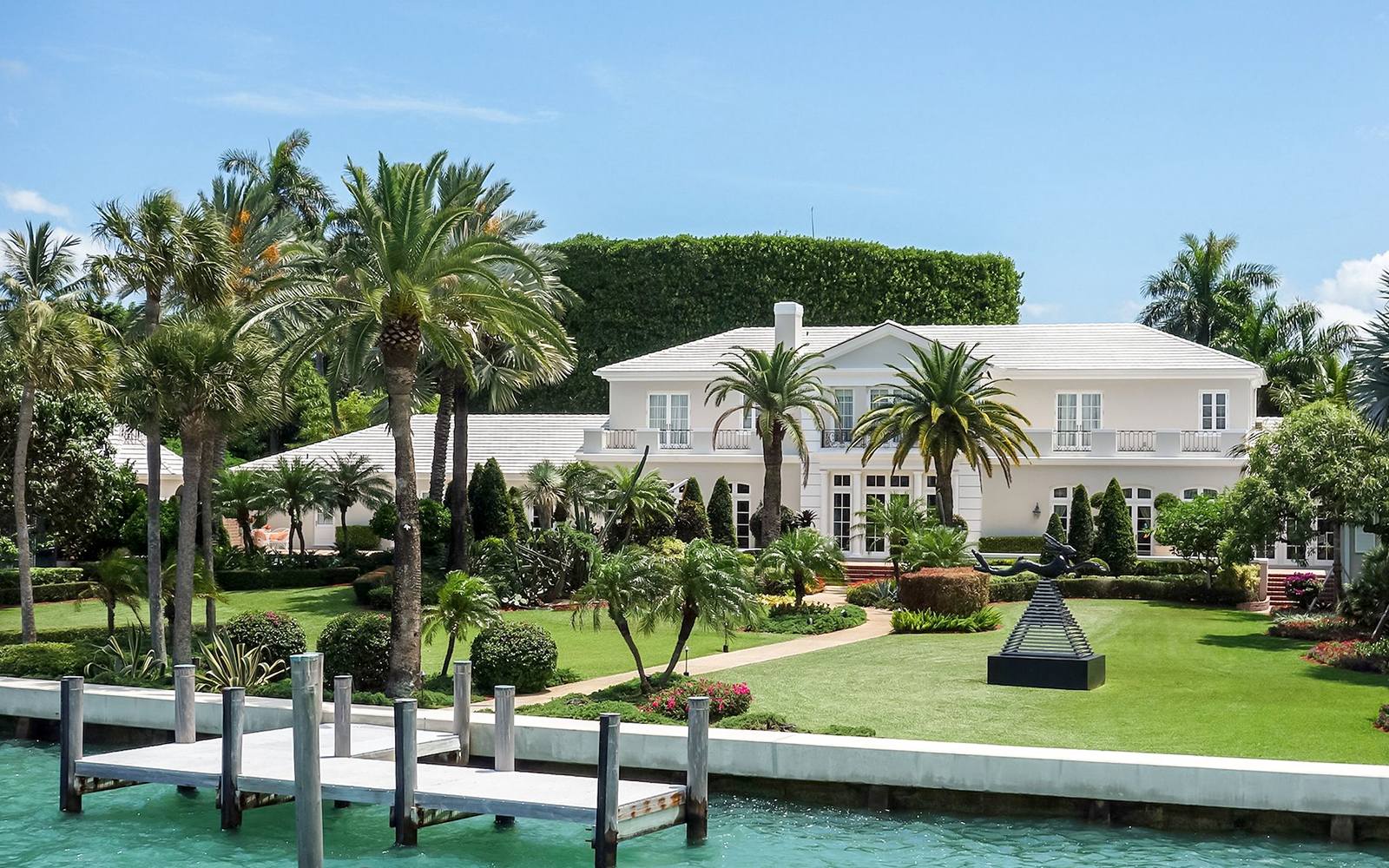 Luxury mansion with palm trees viewed from Miami Skyline Cruise.