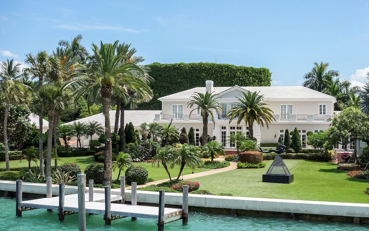 Luxury mansion with palm trees viewed from Miami Skyline Cruise.