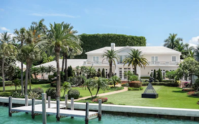 Luxury mansion with palm trees viewed from Miami Skyline Cruise.