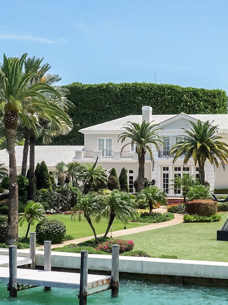 Luxury mansion with palm trees viewed from Miami Skyline Cruise.