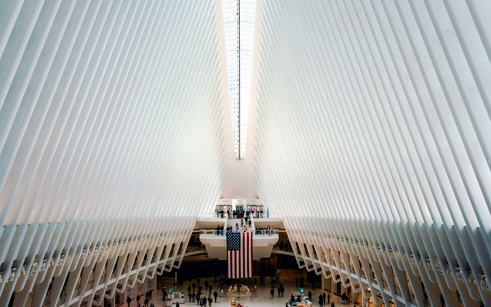 Interior view of The Oculus in New York City with people and American flag.