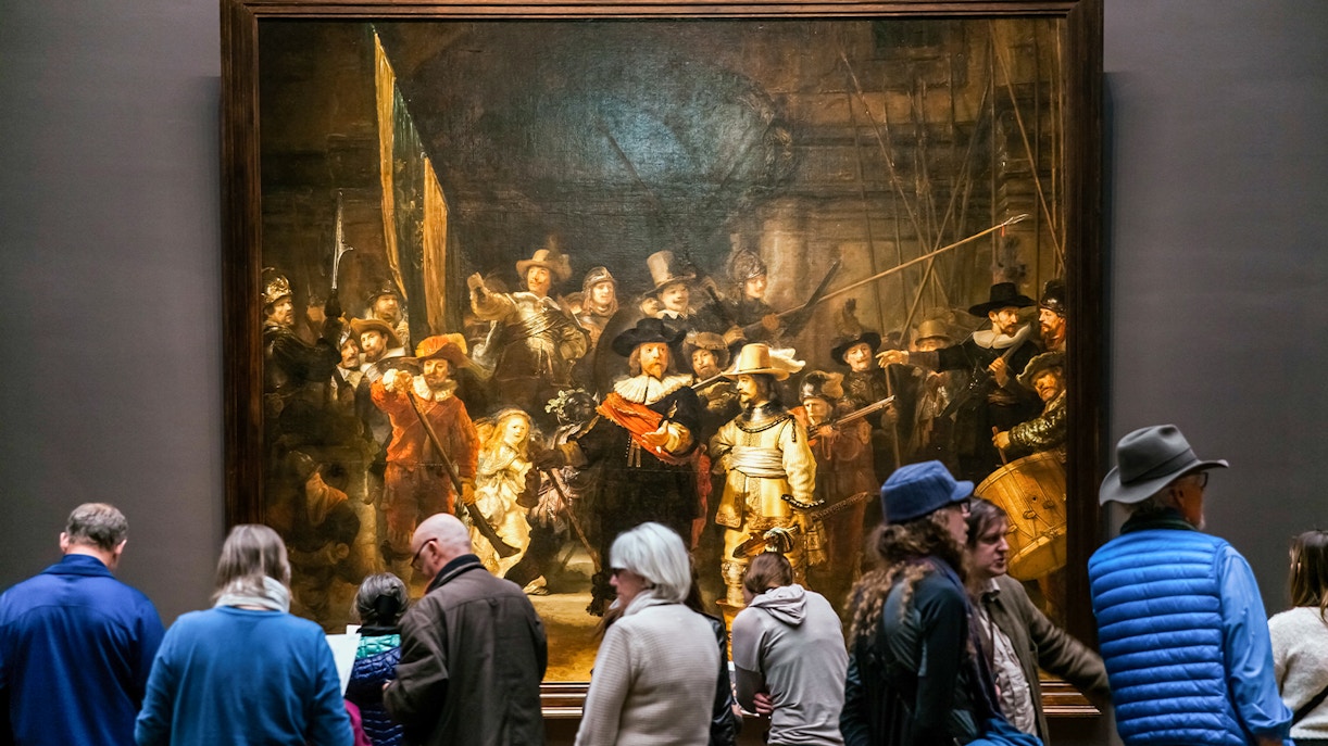 Visitors viewing 'The Night Watch' by Rembrandt at Rijksmuseum, Amsterdam.