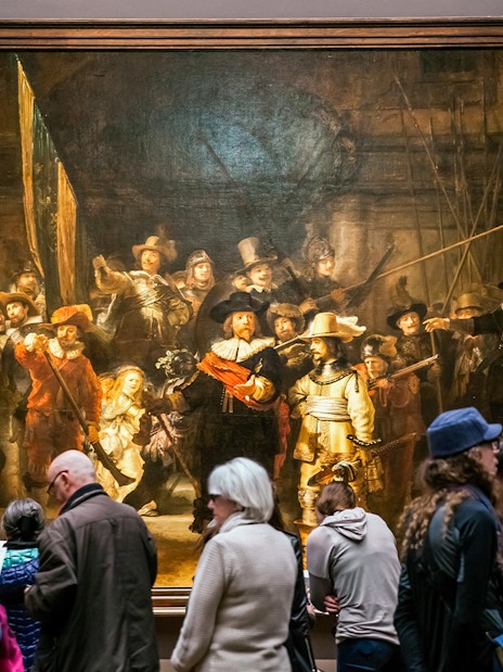Visitors viewing 'The Night Watch' by Rembrandt at Rijksmuseum, Amsterdam.