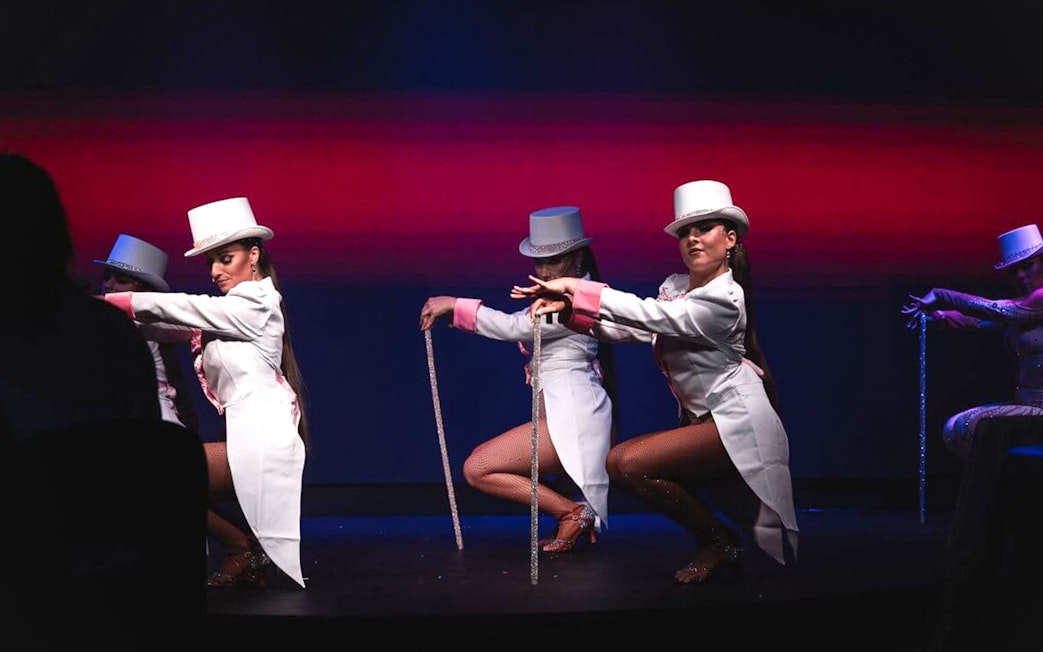 Cabaret dancers in white costumes performing at La Scène Dinner Show, Prague.