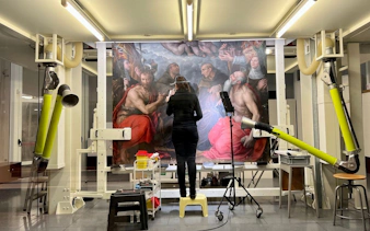 Art restoration at Pinacoteca di Brera, Milan, with a conservator working on a large painting.