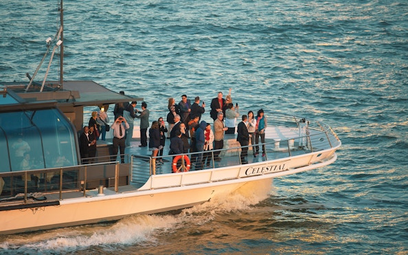 Cruise ship "Celestial" with passengers on deck enjoying the ocean view.